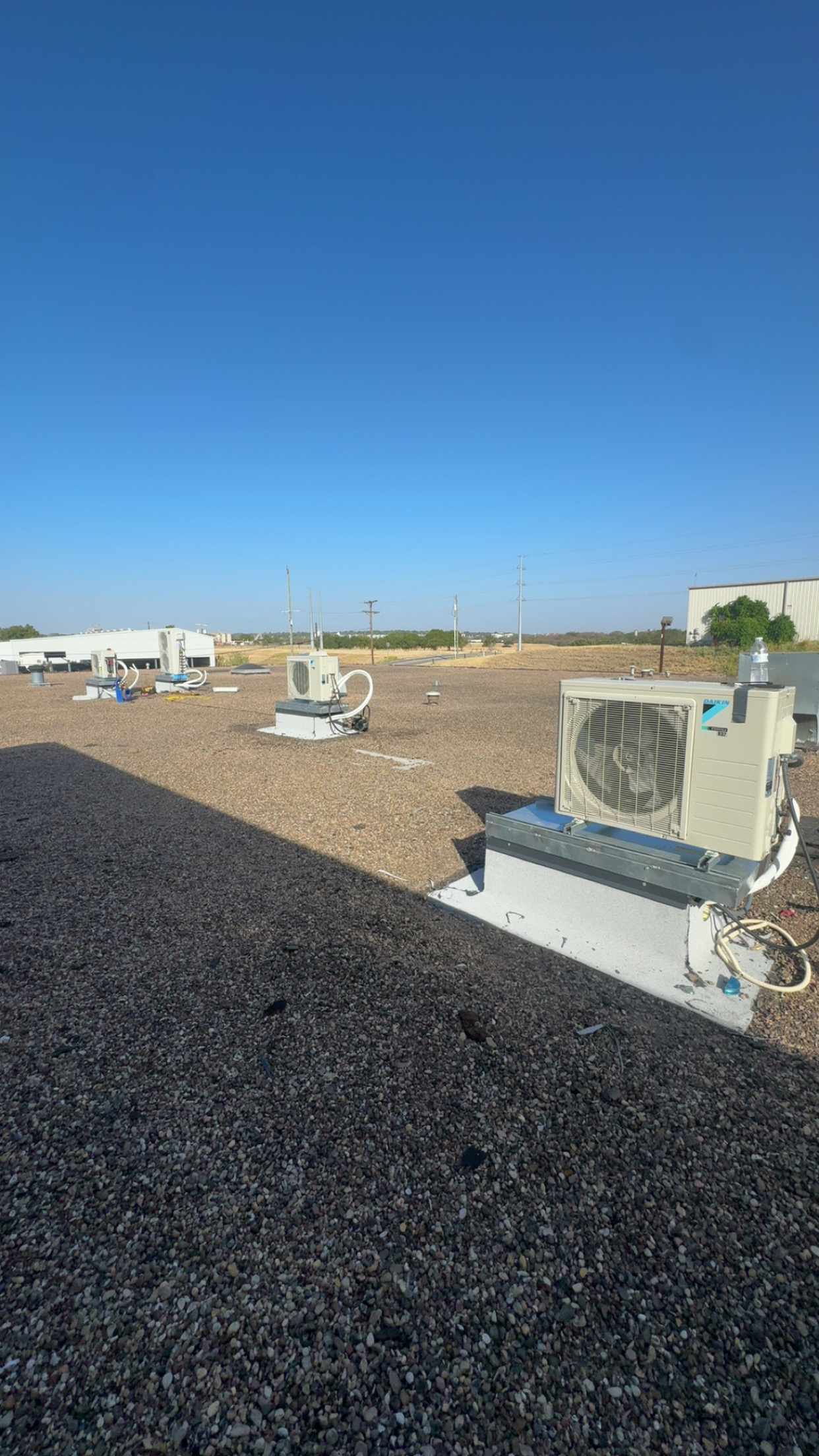 Multiple Daikin mini-split outdoor units on a commercial rooftop
